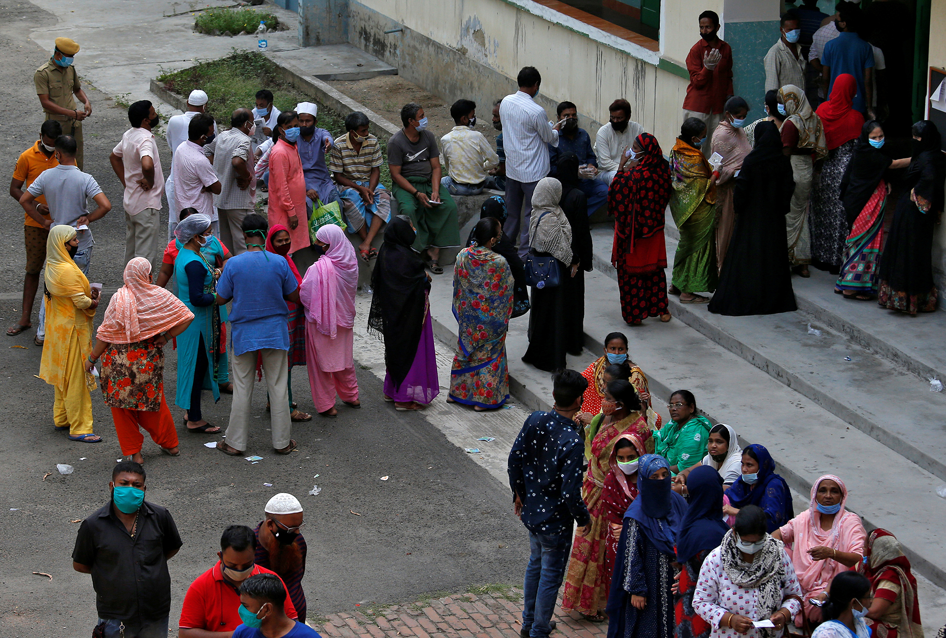 People wait to cast their votes at a polling station in Kolkata